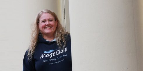 MageQuill founder Marianne Rugard Jarvstrat smiling at the camera wearing a sweatshirt with the wordd 'MageQuill - Inspiring Dreams, www.magequill.com' written on it
