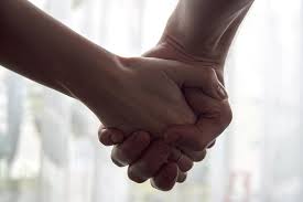 Close-up shot of two intertwined hands