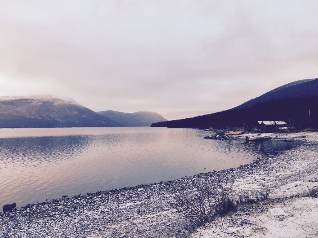 Sight with a lake, mountains, and a cottage in Ammarnas in Swedish Lapland