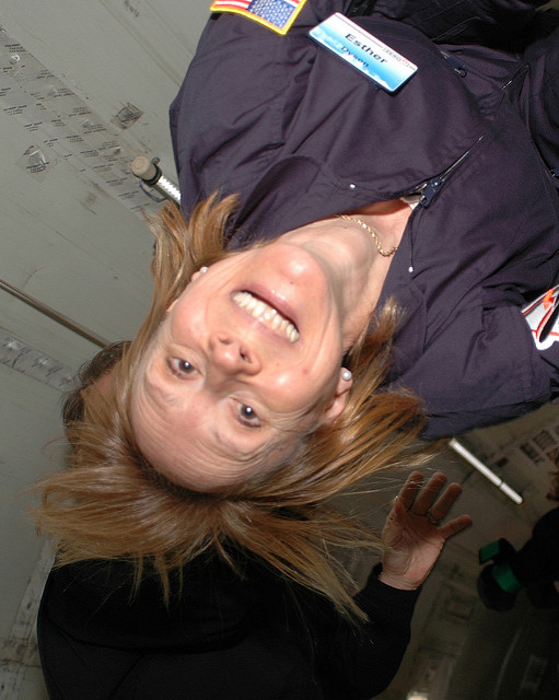 Esther Dyson upside down inside a zero-g stimulator smiling at the camera