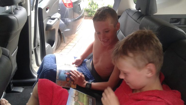 Two boys reading Julie Dakers' book in South Africa