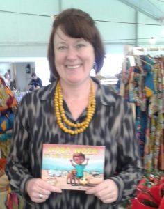 Julie Dakers holding her children's book Woza Woza