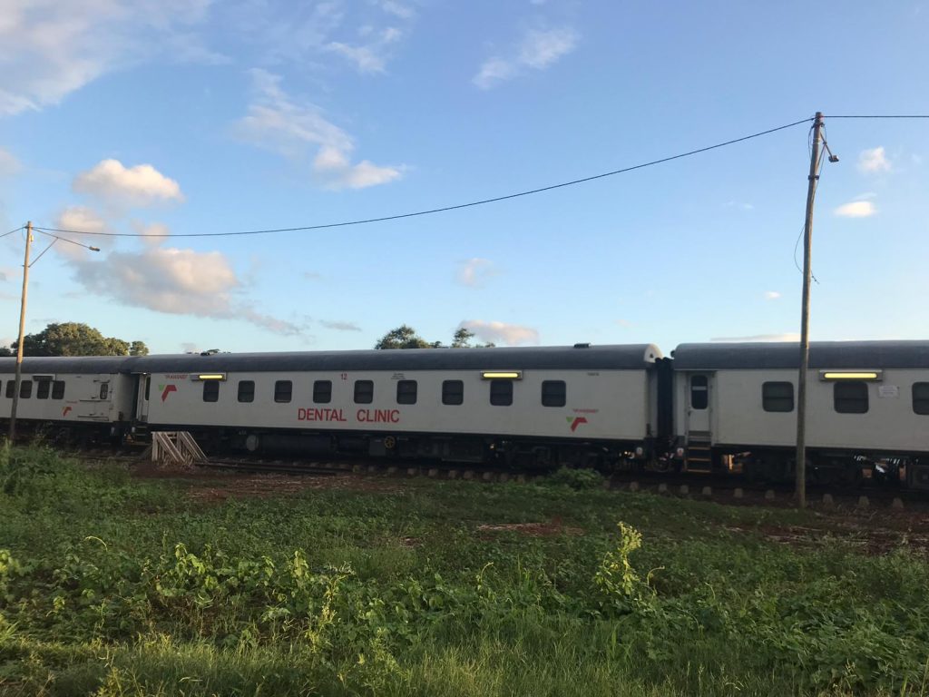 A train-coach in South Africa with the word 'Dental Clinic' written on it