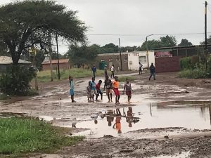 A group of children playing in a puddle in rural South Africa